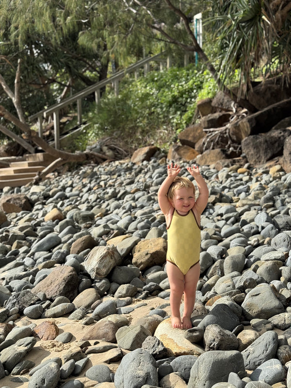 Child in a yellow retro cool swimsuit 